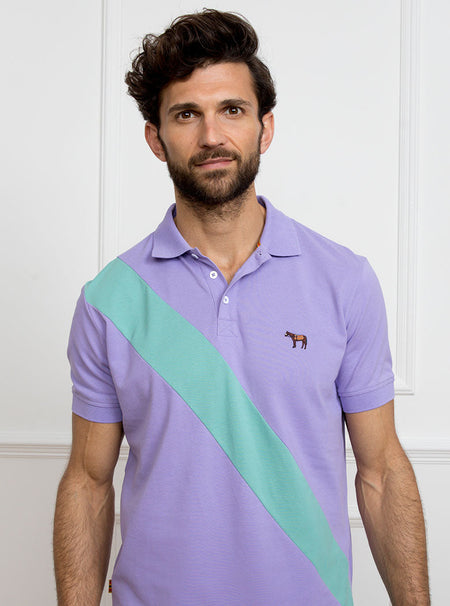 Man wearing lilac 100% cotton polo shirt with avocado green sash detail and Newmarket 875 horse logo embroidered on the front.